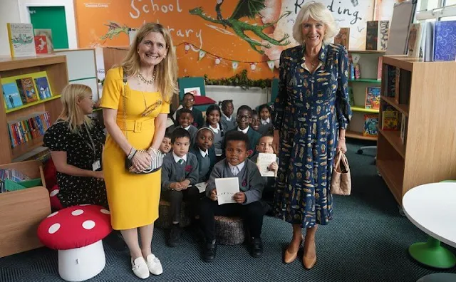 The Duchess of Cornwall wore a navy blue, feather-print dress from Fiona Clare