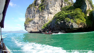 Longtail boat ride from Ao Nang to Railay - another longtail boat below the cliffs