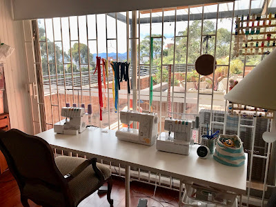 Pretty shared sewing room with lots of natural light and a view.