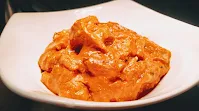 Marinating chicken pieces with spices for chicken Tikka masala recipe