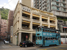 Hong Kong tram with a "Meet The T. Rex" ad going by The Pawn in Wan Chai, Hong Kong