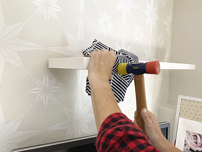 rubber mallet banging shelf onto bracket