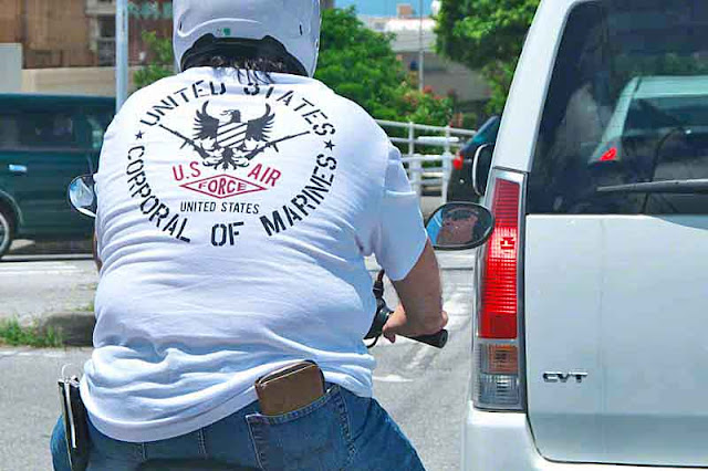 Motor scooter rider wearing Ari Force Marine t-shirt