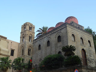 The Church of San Cataldo, with its Norman bell tower and spherical red domes of Islamic influence