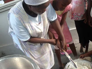 Family in Kenya cooking Ugali
