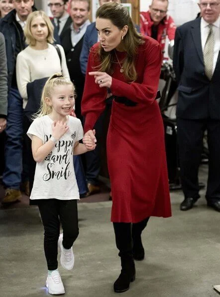 Kate Middleton wore a new navy coat by Hobbs London, and a new knitted puff-sleeve midi dress by Zara. Beulah London Kamala scarf