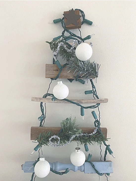 ornaments and greens on a scrap wood tree