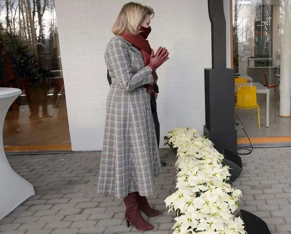 The Queen Elisabeth Music Chapel. Queen Mathilde wore a checked print long coat from Natan, and burgundy mask from Natan, Armani silk blouse