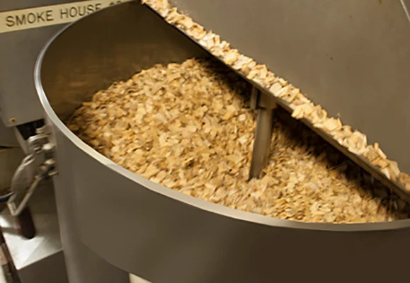 Hickory wood chips in smoker at Fresh Mark Company, Massillon, OHIO