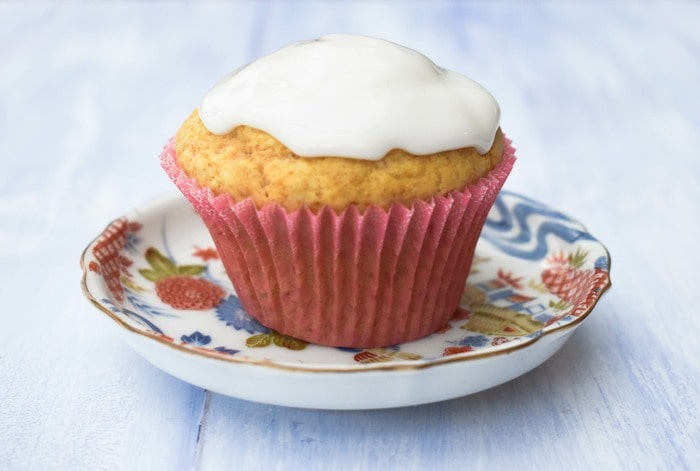 Iced lemon muffin on a teaplate