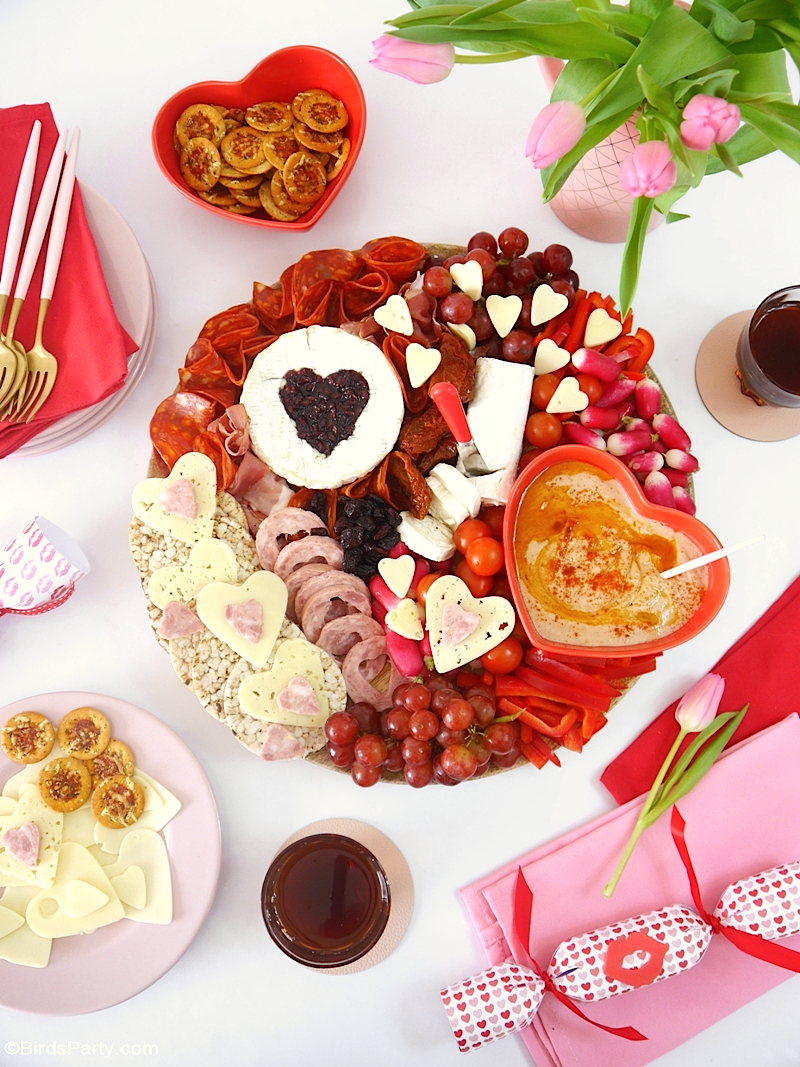 Valentine's Day Cheese and Charcuterie Board - easy, pretty, delicious grazing board filled with pink & red foods to celebrate love day at home! by BirdsParty.com @birdsparty #cheeseboard #charcuterieboard #valentinesday #recipes