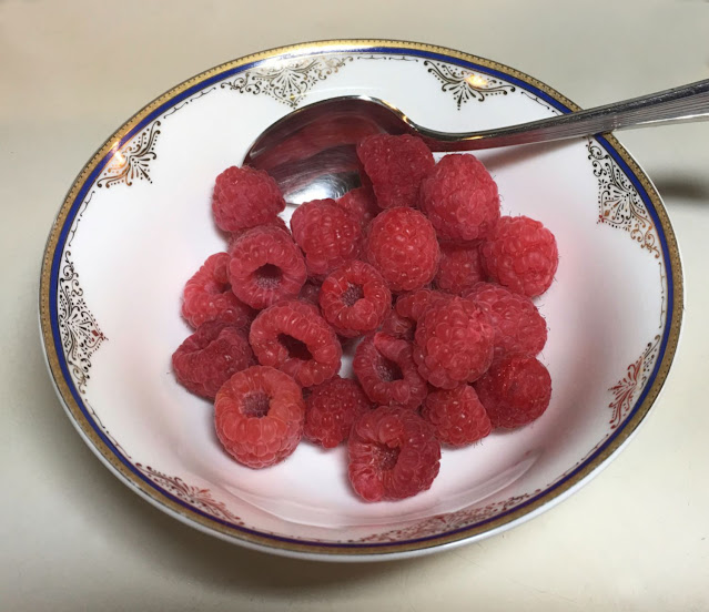 Bowl of fresh organic raspberries after 6 days of refrigerator storage