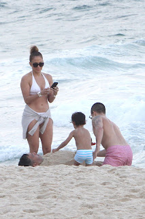 Jennifer Lopez taking photos of her twins playing on a sandy beach in Rio