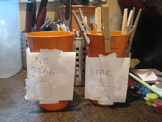 Clothes-pegs on cups reward system for star chart