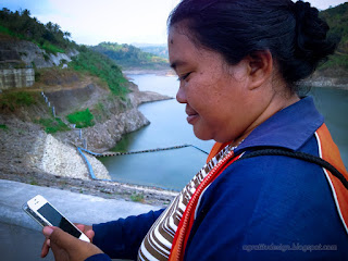 Woman Traveler Checking Her Smartphone Above The Dam In The Dry Season At Titab Ularan Village North Bali Indonesia