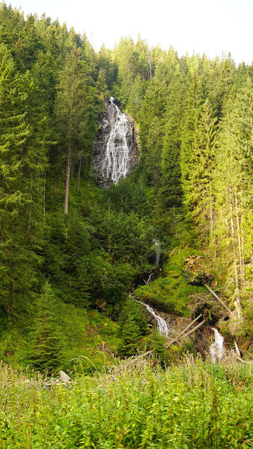 The scenery with a waterfall representing the free-flowing nature of experiences.