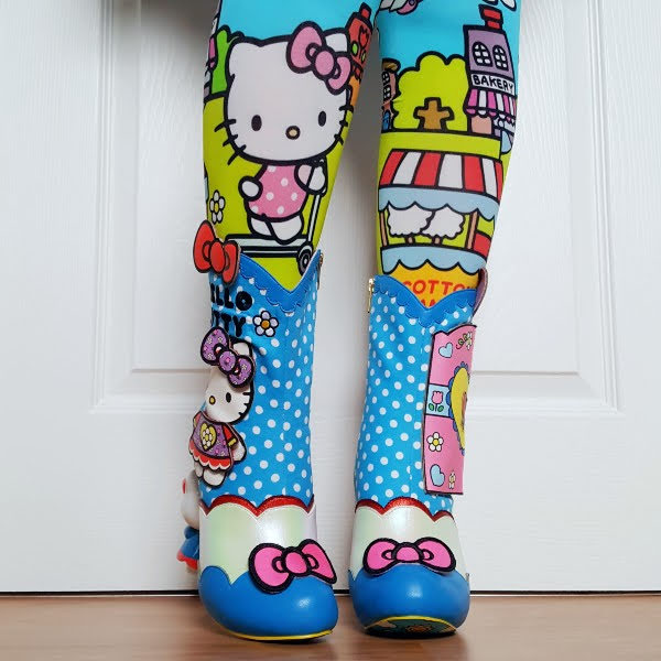 wearing patterned Hello Kitty tights with blue spotty ankle boots with pink bows