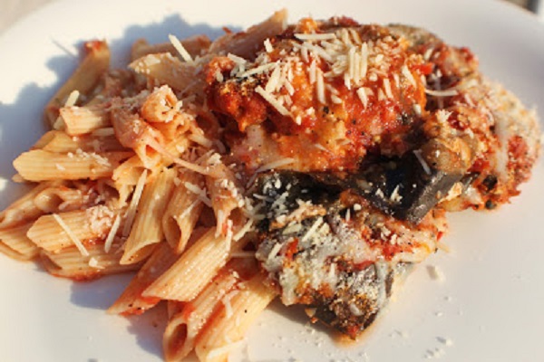this is penne pasta with eggplant parmesan baked on top