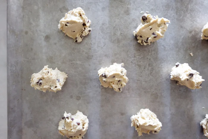 cookie dough balls on insulated baking sheet