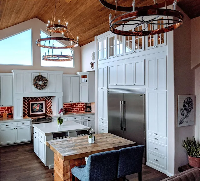 white kitchen with red brick