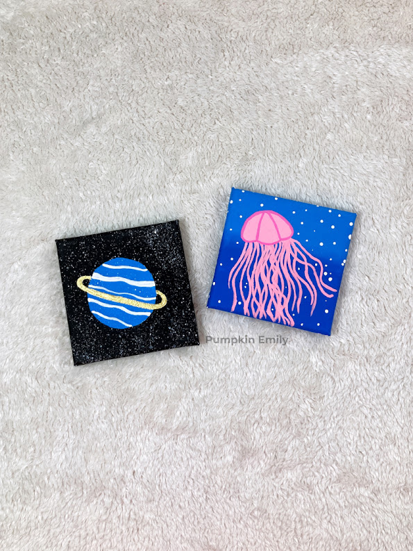 A jellyfish and planet canvas painting.