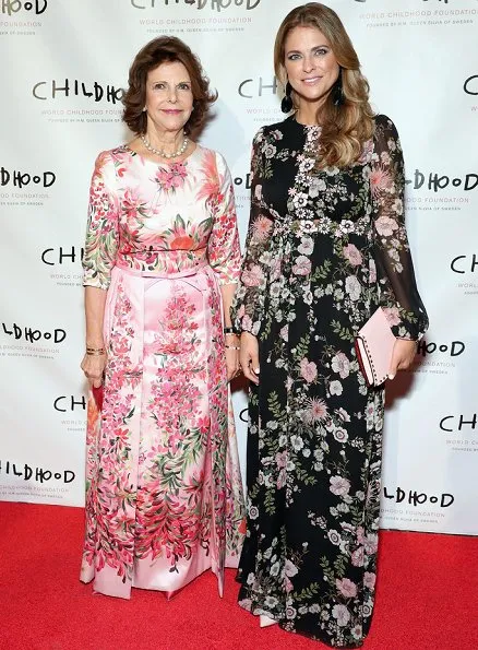 Princess Madeleine wore Giambatista ValliI floral print gown, and she carried Valentino Pink Rockstud clutch bag, Silvia wore a floral dress