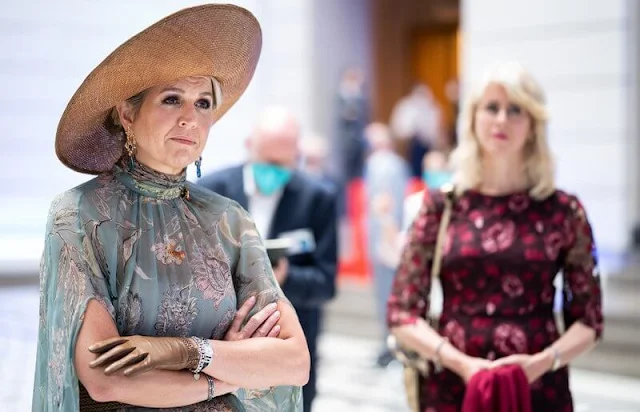 Queen Maxima wore a floral print dress from spring summer 2020 collection of Natan. Gold diamond earrings from Ole Lynggaard