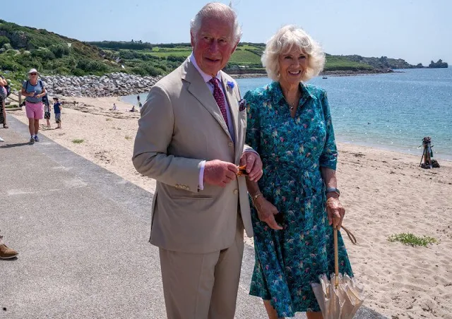 The Duchess wore a hawaiian summery print turquoise blue shirt dress. Prince Charles and Camilla met schoolchildren in St Mary