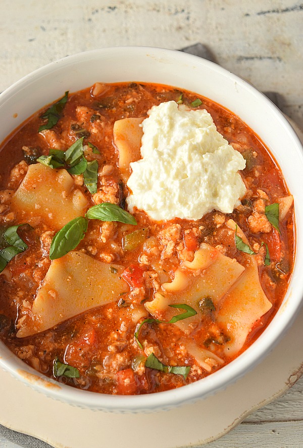 birdseye view of a white bowl with one pot lasagna soup topped