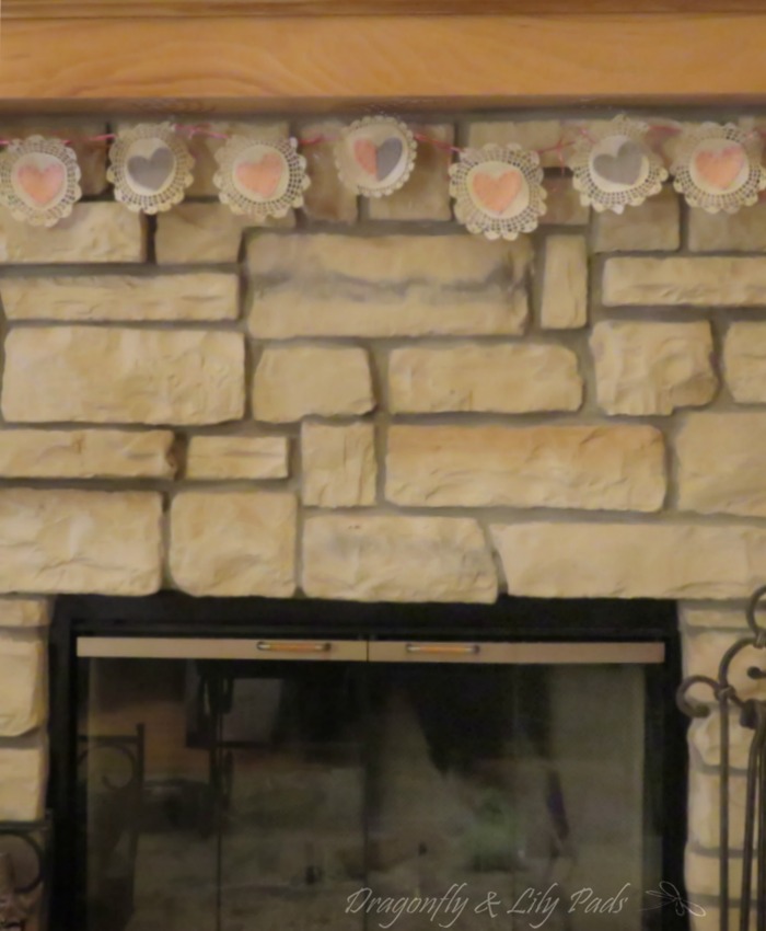 Vintage Heart Valentine's Garland made with Cricut hung on the fireplace in our sunroom. 