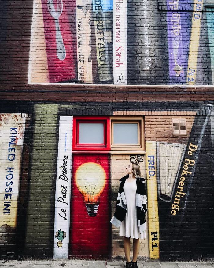 Dutch Artists Paint An Enormous Bookcase On An Apartment Building That Features Residents’ Favorite Books