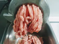 Making Chicken mince in a meat mincer