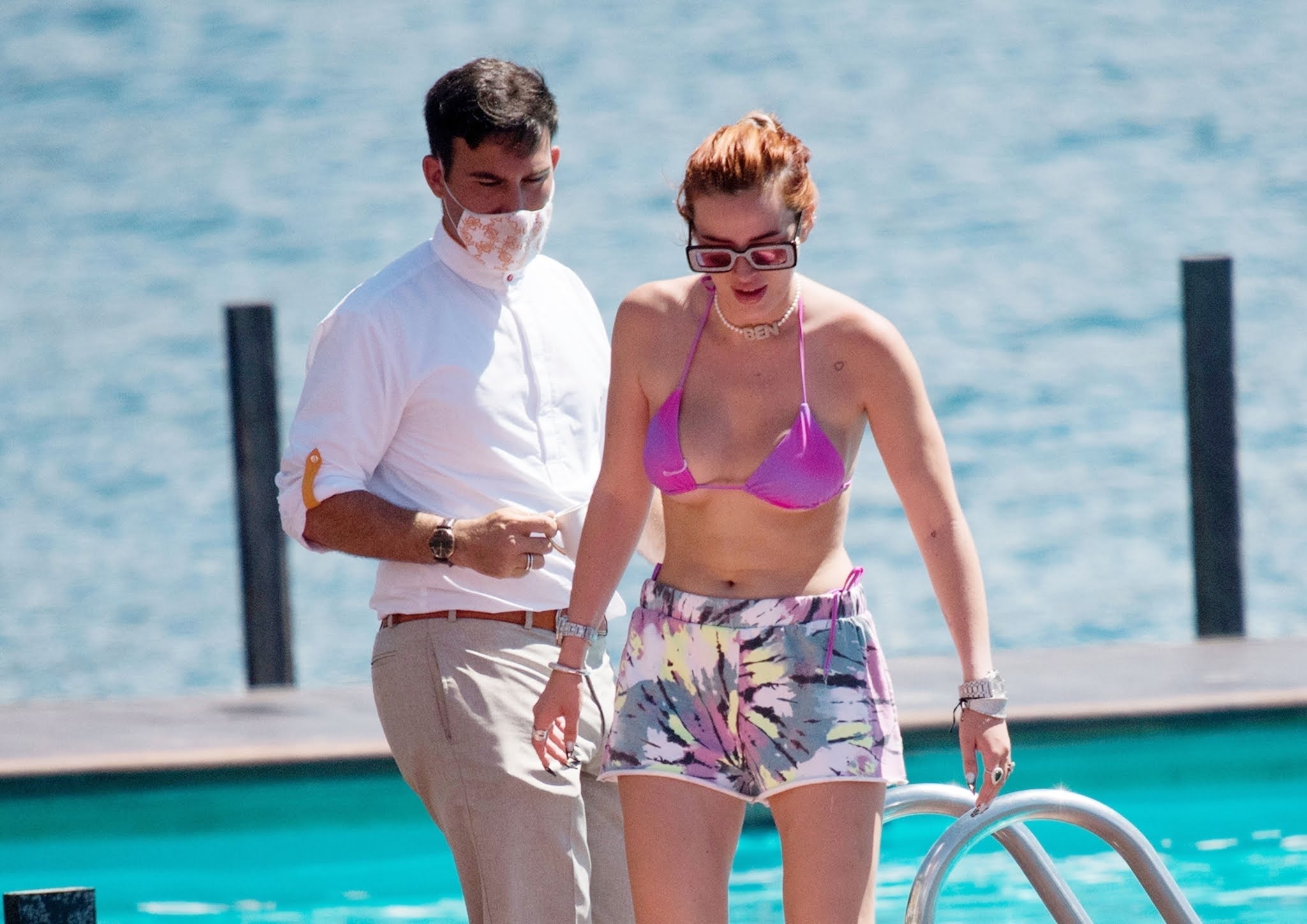 Bella Thorne shows off her toned figure in a tiny purple bikini in Italy