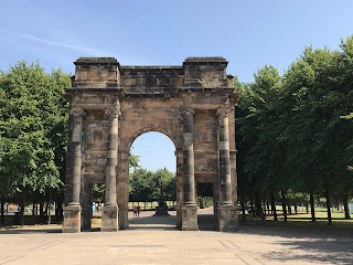 The McLennan Arch at the Saltmarket entrance to Glasgow Green.  A photo showing a large, stone arch with trees and a path leading under and through it.  Photo by Kevin Nosferatu for The Skulferatu Project.