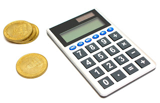 Calculator & gold coins; source:http://www.freestockphotos.biz; by Benjamin Miller