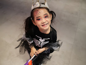 girl dressed up as a skeleton queen posing for a photo