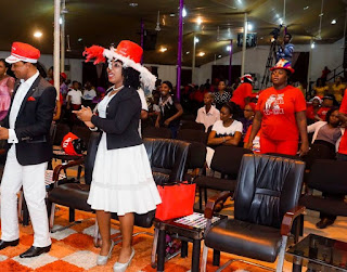 congregation singing the first noel during christmas carol night programme