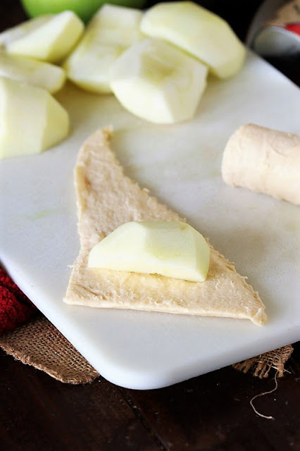 Apple Quarter on Crescent Roll Dough Triangle to Make Crescent Roll Apple Dumplings Image