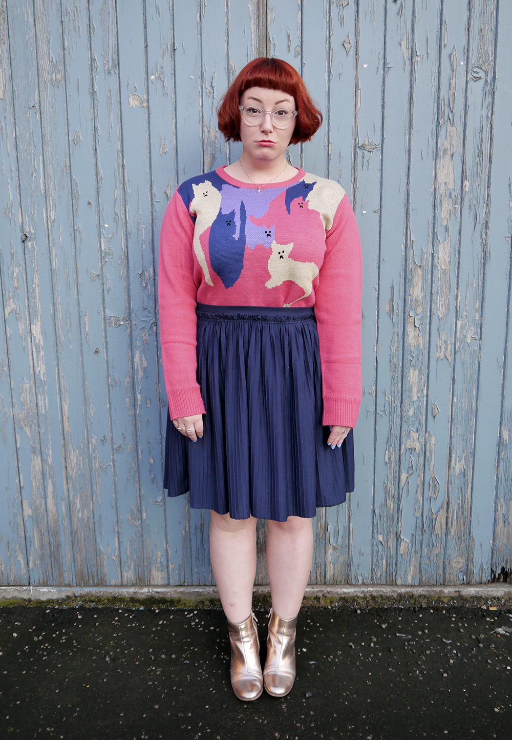La La Land Cat Jumper Styled by Helen, Scottish blogger, Dundee blogger, Scottish fashion blogger, quirky style, Scottish street style, cute style, cat clothing, dressing to a theme, cat themed clothing, cat jumper, colourful outfit, colourful street style, La La Land, colourful cat jumper, pink jumper, pink and blue outfit, red head, ginger bob, clear glasses, Iolla glasses, cat necklace, silver cat necklace, gold boots, cat pose, cute cat outfit, Wardrobe Conversations, silly face