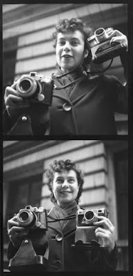 black and white photograph of young Ida Wyman with 2 of her cameras