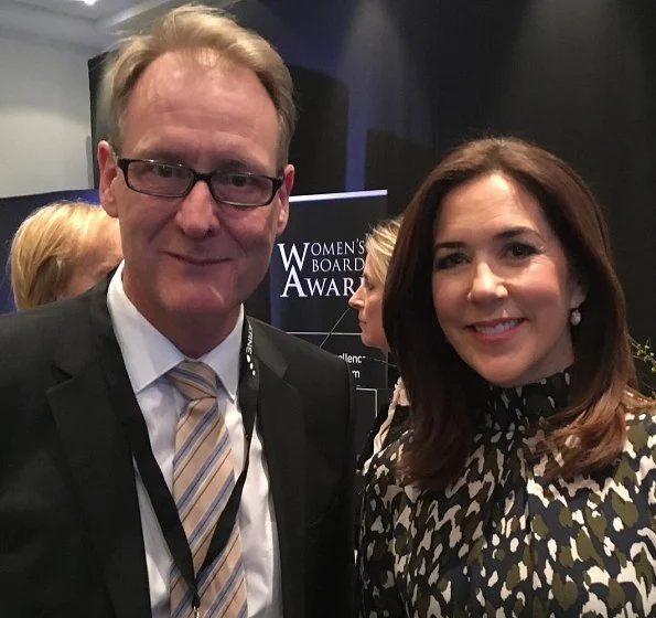 Danish Crown Princess Mary to the winner of the award, CSM's President Marianne Kirkegaard. Princess Mary wore leather skirt and print blouse