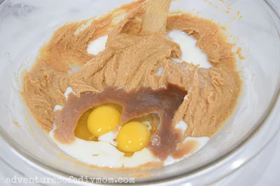 adding the eggs, milk and vanilla to peanut butter cookie batter