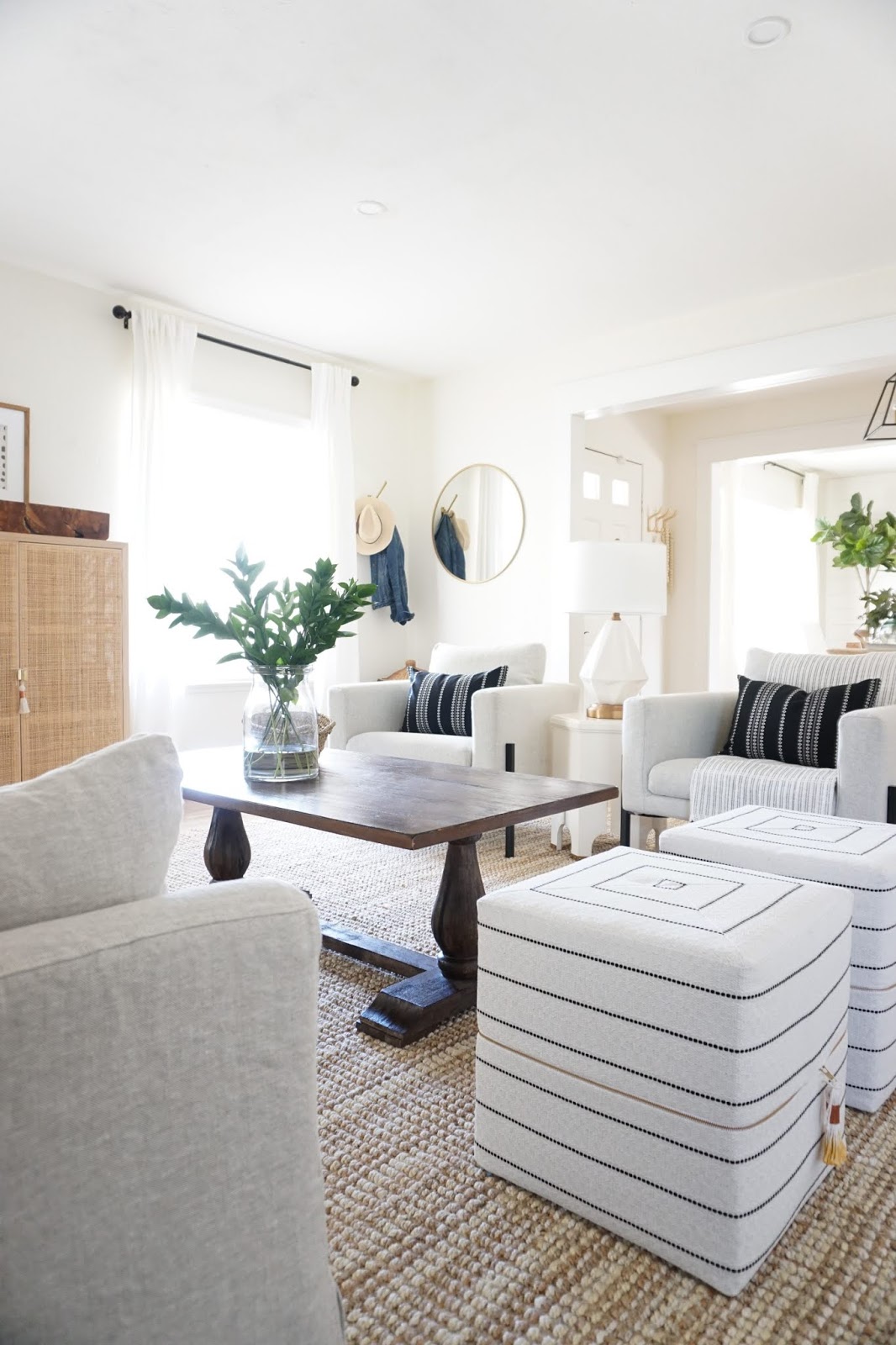 Living room design with natural rug and white furniture