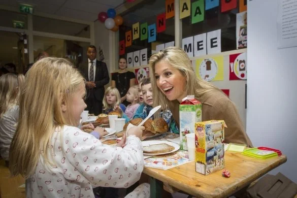 Dutch Princess Maxima attends the national school breakfast at the Zonnewijzer school in Leidschendam on a very windy day. she wore Natan dress