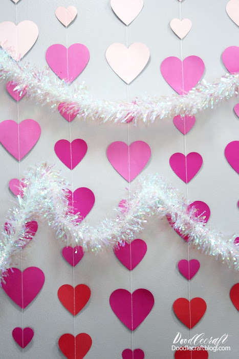 Ombre hearts in light pink, hot pink and red with holographic tinsel garland make the perfect Valentine backdrop or photo op.