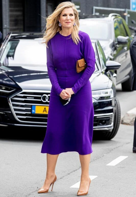 Queen Maxima wore a puffled sleeves dolman midi dress from Victoria Beckham, and yellow floral print silk satin dress from Natan