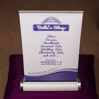 Photograph of small A4 pop up banner on a cusion. Printed in full colour with purple and greys, fitted in the banner holder.