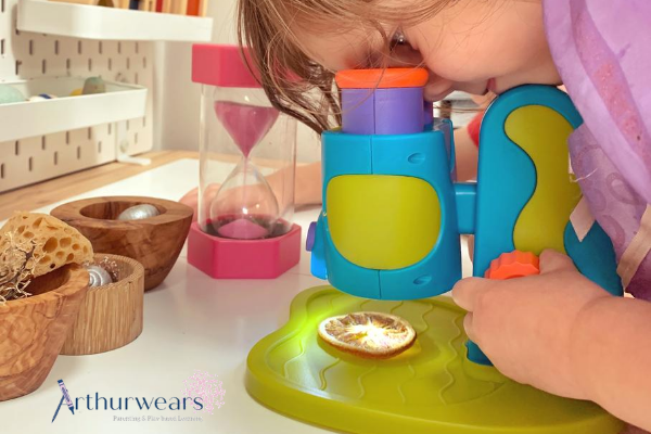 Child looking through Learning Resources first microscope