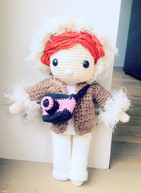 Crochet pattern amigurumi doll girl in winter coat and photo camera