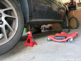 car on jack stands and wheel ramps, creeper dolly